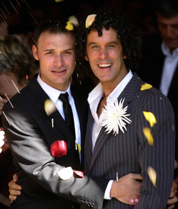 Madrid, SPAIN:  Madrid City Councillor and Socialist Party Executive Board member Pedro Zerolo (R) smiles with his partner Jesus Santos (L) 01 October  2005 under falling flower petals after getting married in a civil ceremony in central Madrid. AFP PHOTO/ Pedro ARMESTRE  (Photo credit should read PEDRO ARMESTRE/AFP/Getty Images)
